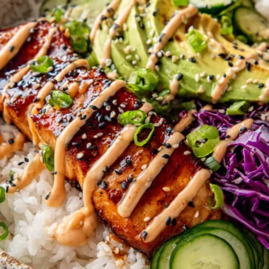 Extreme close up of a vibrant crispy salmon and rice bowl with glossy soy ginger glaze