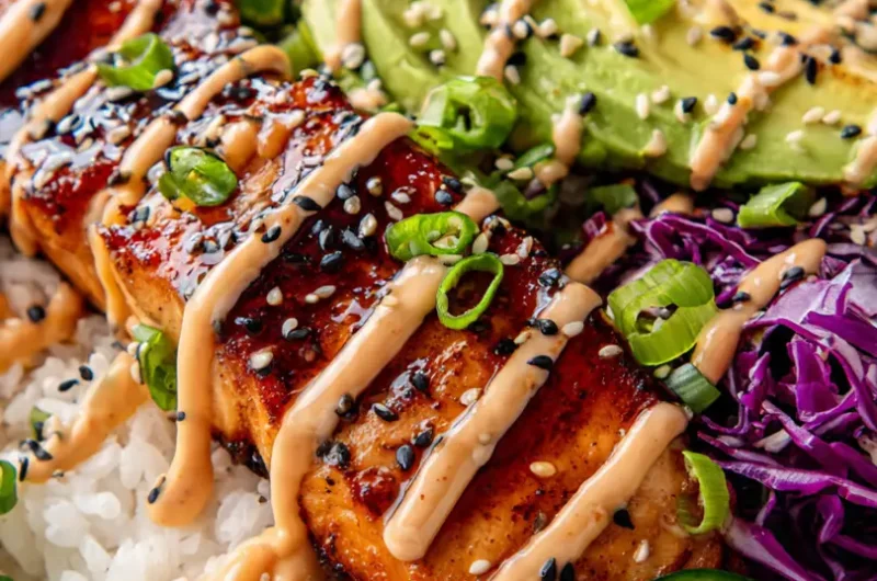 Extreme close up of a vibrant crispy salmon and rice bowl with glossy soy ginger glaze
