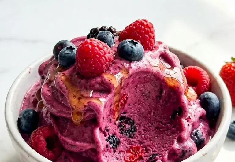 Tall vertical close-up of blender protein sorbet with fresh berries in a white bowl for Pinterest