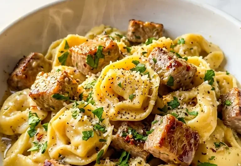 Pinterest pin image for garlic steak tortellini in creamy parmesan sauce