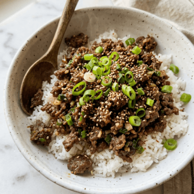 Korean ground beef bowl with glossy savory sauce over jasmine rice topped with sesame seeds