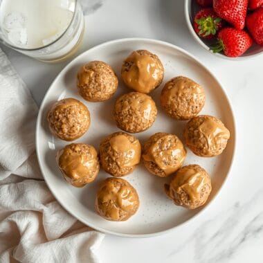 Overhead view of peanut butter energy bites with milk and strawberries