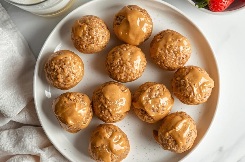 Overhead view of peanut butter energy bites with milk and strawberries