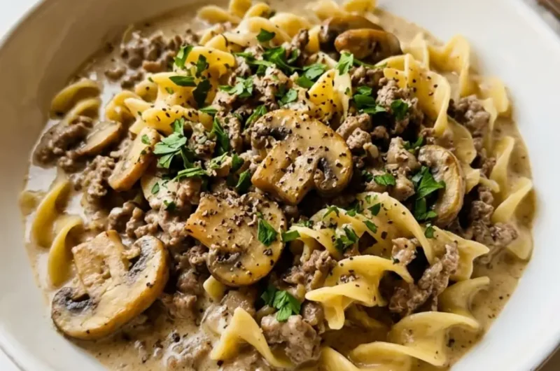 easy ground beef stroganoff in a white ceramic bowl with fresh parsley
