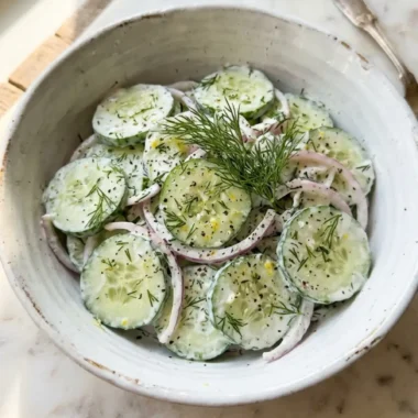 Cucumber Dill Salad in 10 Minutes: Best Fresh Healthy Side Dish 5 creamy cucumber dill salad in a white ceramic bowl with fresh dill and scallions