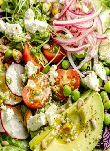 Close-up of Everything Spring Green Salad with Basil Lemon Vinaigrette freshly made and ready to serve