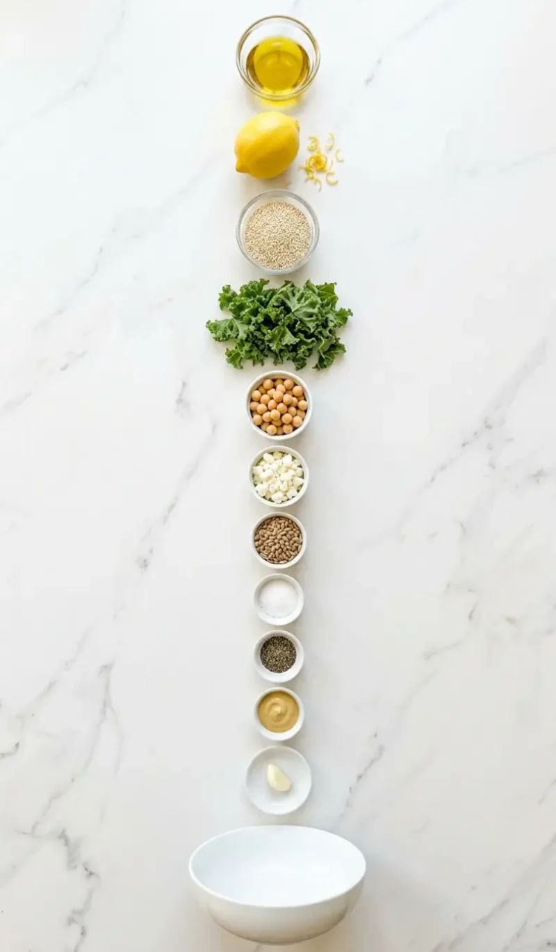all 11 ingredients for kale quinoa salad with lemon dressing arranged on white marble